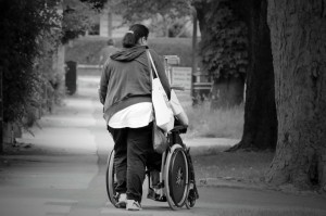 woman pushing a wheelchair