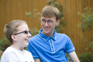 young carer, caring for brother, outside